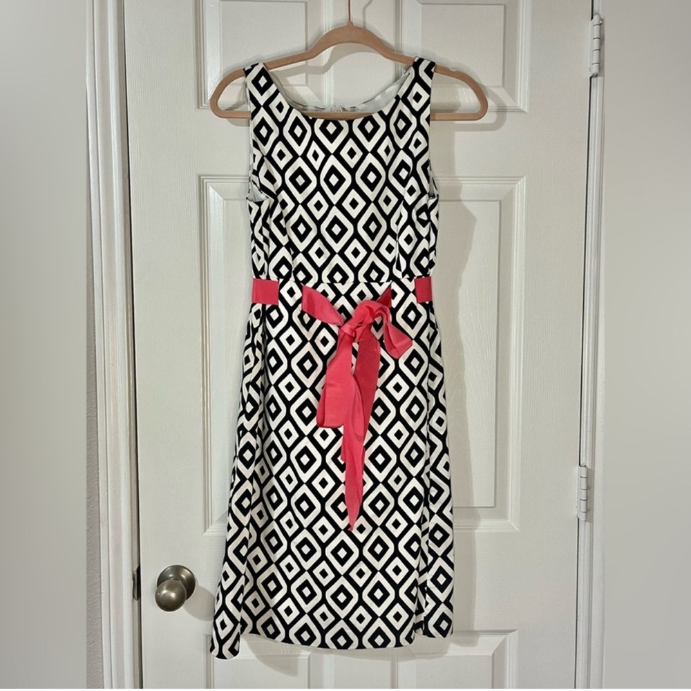 Black and white geometric dress with pink belt bow